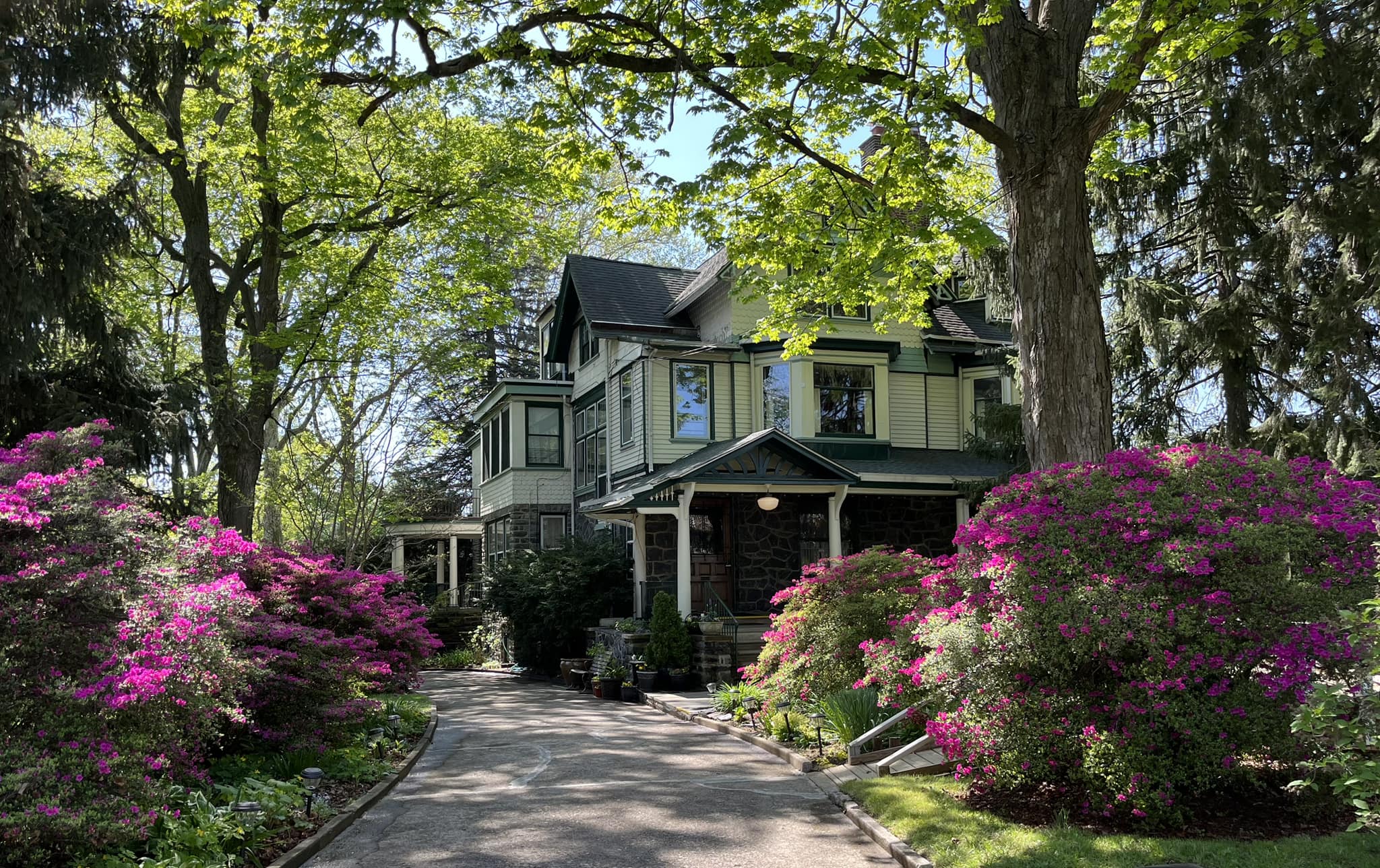 Bahá'í Center of Philadelphia surrounded by blooming azaleas